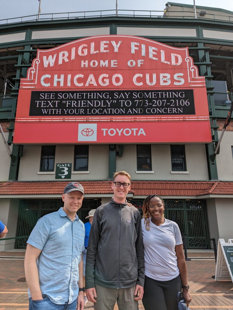 Kyle, Adam, and Chisom at Wrigley Field before ISMS 2023